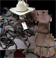 Old straw cowboy hat, horse tack, saddlebags