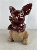 Brown dip glazed cement pig. Approximately 10