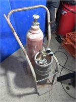 Empty oxygen/acetylene bottles, cart, couple