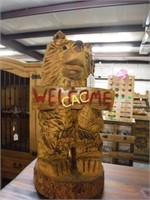 Carved Bear holding a  "Welcome" Sign
