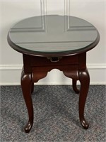 Mahogany Oval Queen Anne style table with a glass