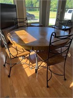 Round top table with metal base and four chairs