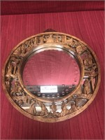 Round Asian influence mirror with carved wood