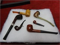 Small & miniature pipe collection in showcase.