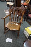 antique tiger oak rocking chair with ornate carved
