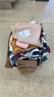 Box of bedding, table cloths, and more