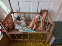 Wooden doll craddle with vintage dolls clothes
