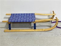 Handmade wooden pulley sled with woven seat