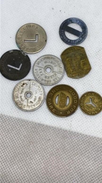 Group of old sales tax and fare tokens