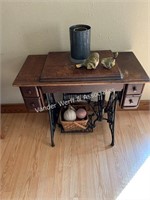 Singer sewing machine in cabinet with décor