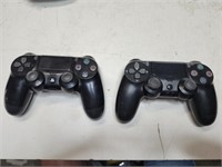 2 black PlayStation wireless controllers.