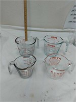 Set of four Pyrex measuring cups