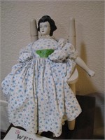 Old doll with wooden rocker