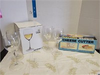 Set of wine glasses and cheese cutter