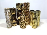 8 assorted gold colored vases.