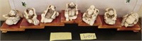 Q - SET OF CARVED IVORY FIGURINES ON DISPLAY STAND