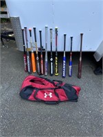 a lot of baseball bats in an under Armour bag