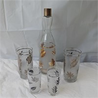 Beautiful bottle and serving glasses with leaves