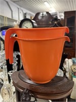 Two orange measuring cups