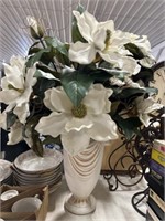 Large white vase and floral arrangement