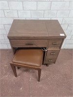 Singer sewing machine in cabinet with bench