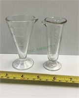Two small vintage and antique medicine beakers