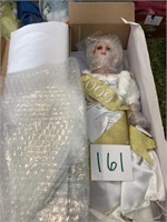 Porcelain angel doll still mostly wrapped in