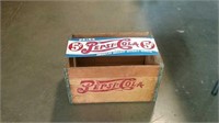 Pepsi-Cola sign and wooden box