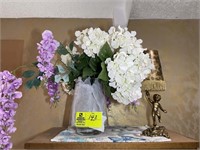 Top of display cabinet including flower vase with