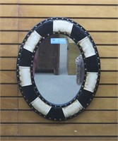 Oval framed black and white mirror