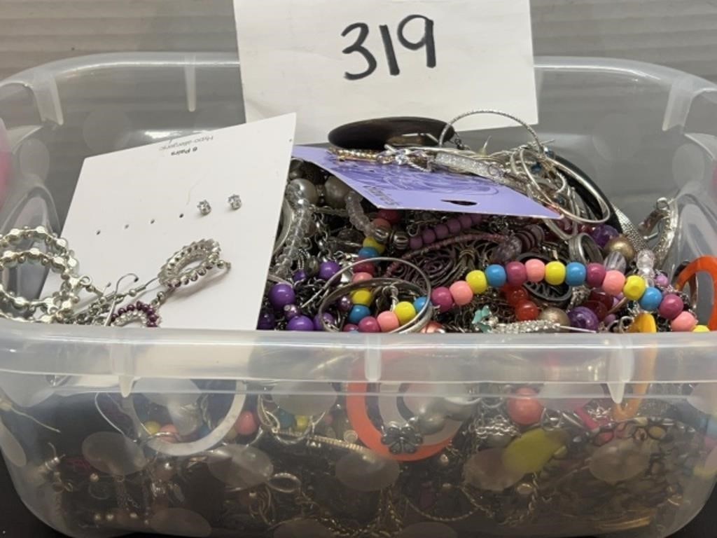 Small container full of mixed jewelry