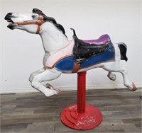 Cast aluminum carousel horse on a Coca-Cola stand