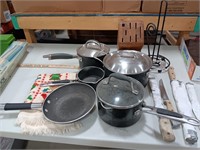 5 pots and pans with 3 lids, 5 knives, paper