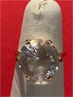 Large white solitaire stone on a 14 K ring. Size