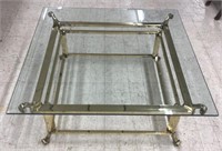 Glass top bronze toned coffee table measuring 40”