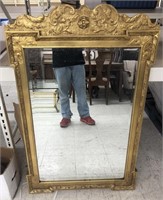 Mirror with gold tone ornate frame measuring