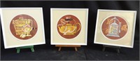 Three framed pictures on stands