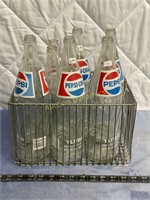 Seven Vintage Glass Pepsi Bottles in Wire Crate
