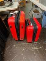 Red hard shell rolling suitcases