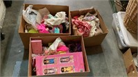 Three boxes of vintage doll and Barbie clothes.