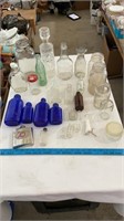 Arious vintage glass bottles, mason jars, cubs