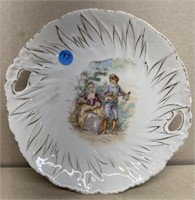 Hand painted plate of boy playing musical to a