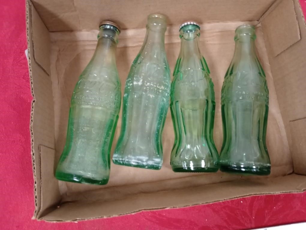 Four Coca-Cola bottles see towns below