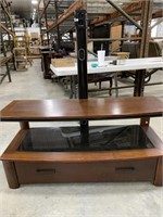 Wooden and glass entertainment center with TV
