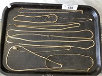 Lot of 9 gold toned necklaces.