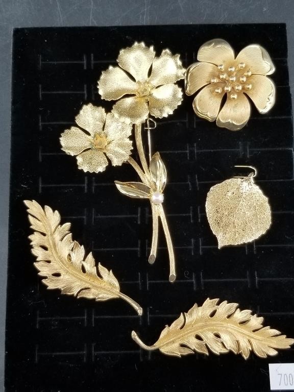 Beautiful gold toned jewelry display with multiple