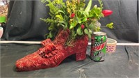 Red shoe plant holder with flowers