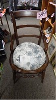 ANTIQUE CHAIR WITH HIP RESTS AND CUSHIONED SEAT