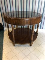 Beautiful Oak Round end table with glass top. 21