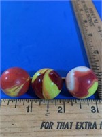 3 yellow and red swirl marbles (oxblood)